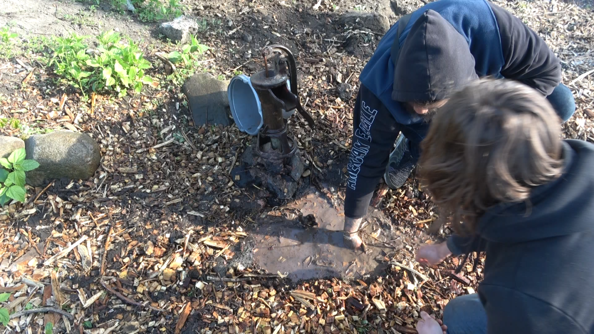 Two people work on a conceptual well