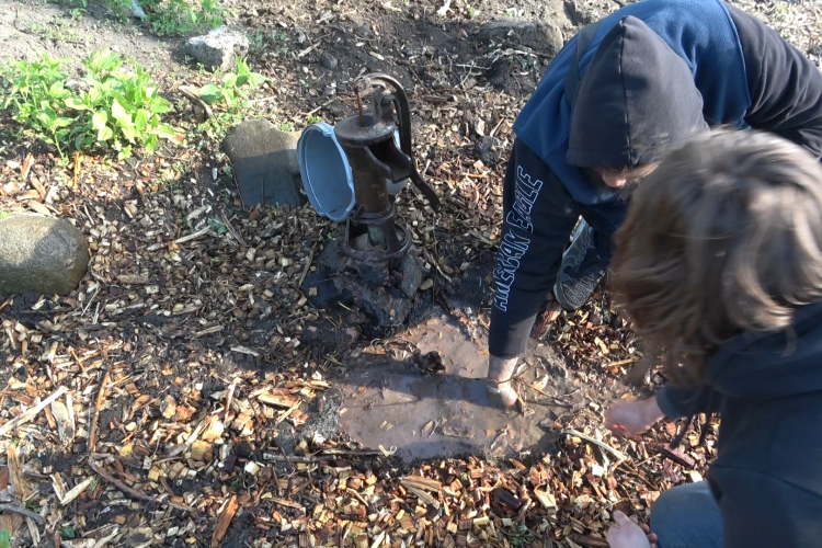 Two people work on a conceptual well